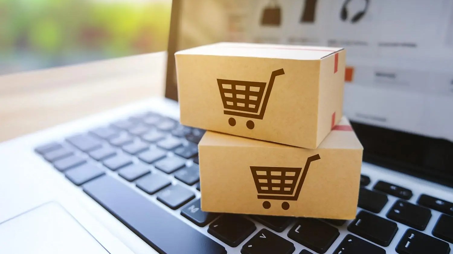 Parcel boxes on a laptop keyboard, direct-to-consumer e-commerce