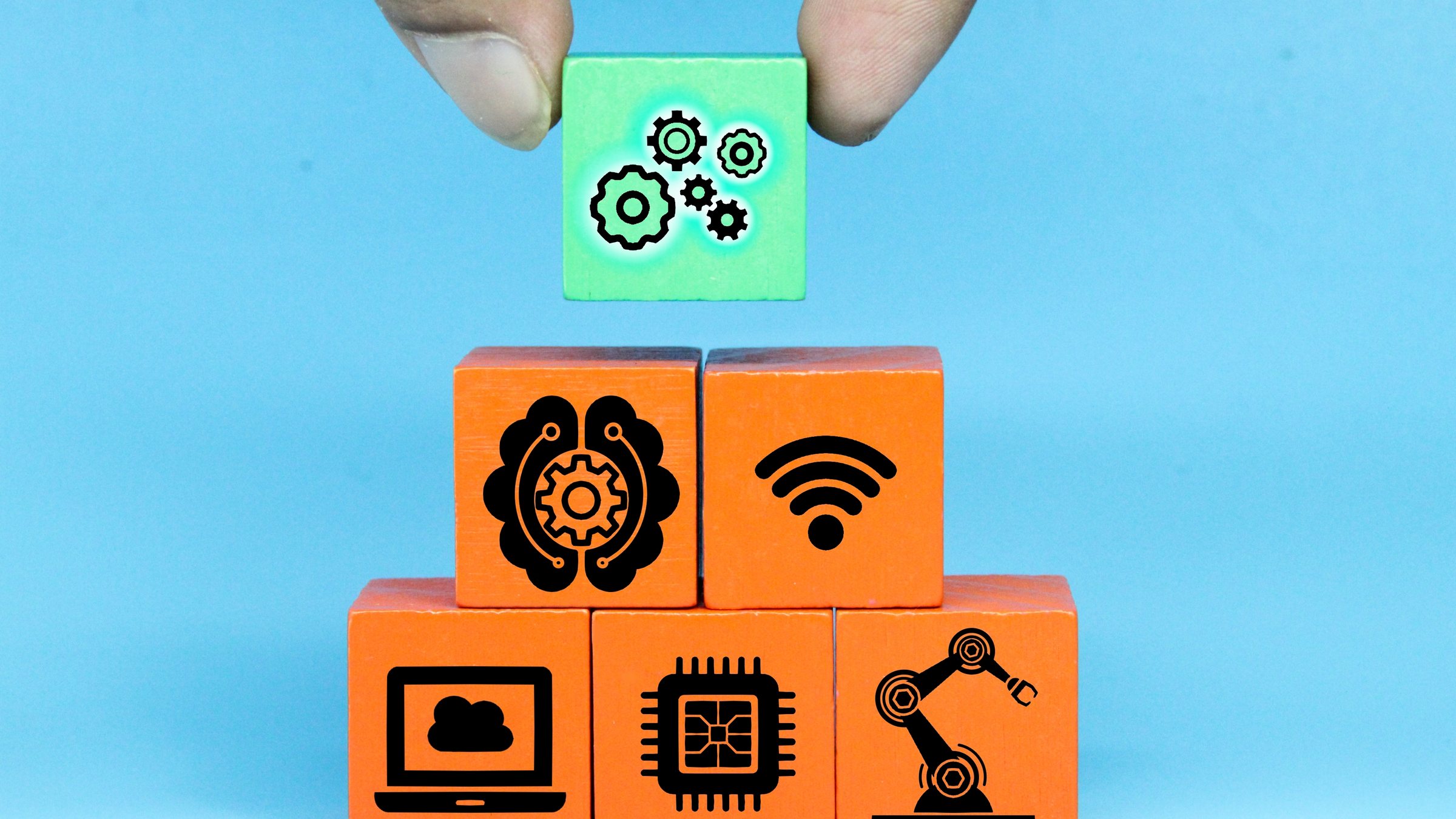 Hand stacking blocks with software icons representing a tool stack