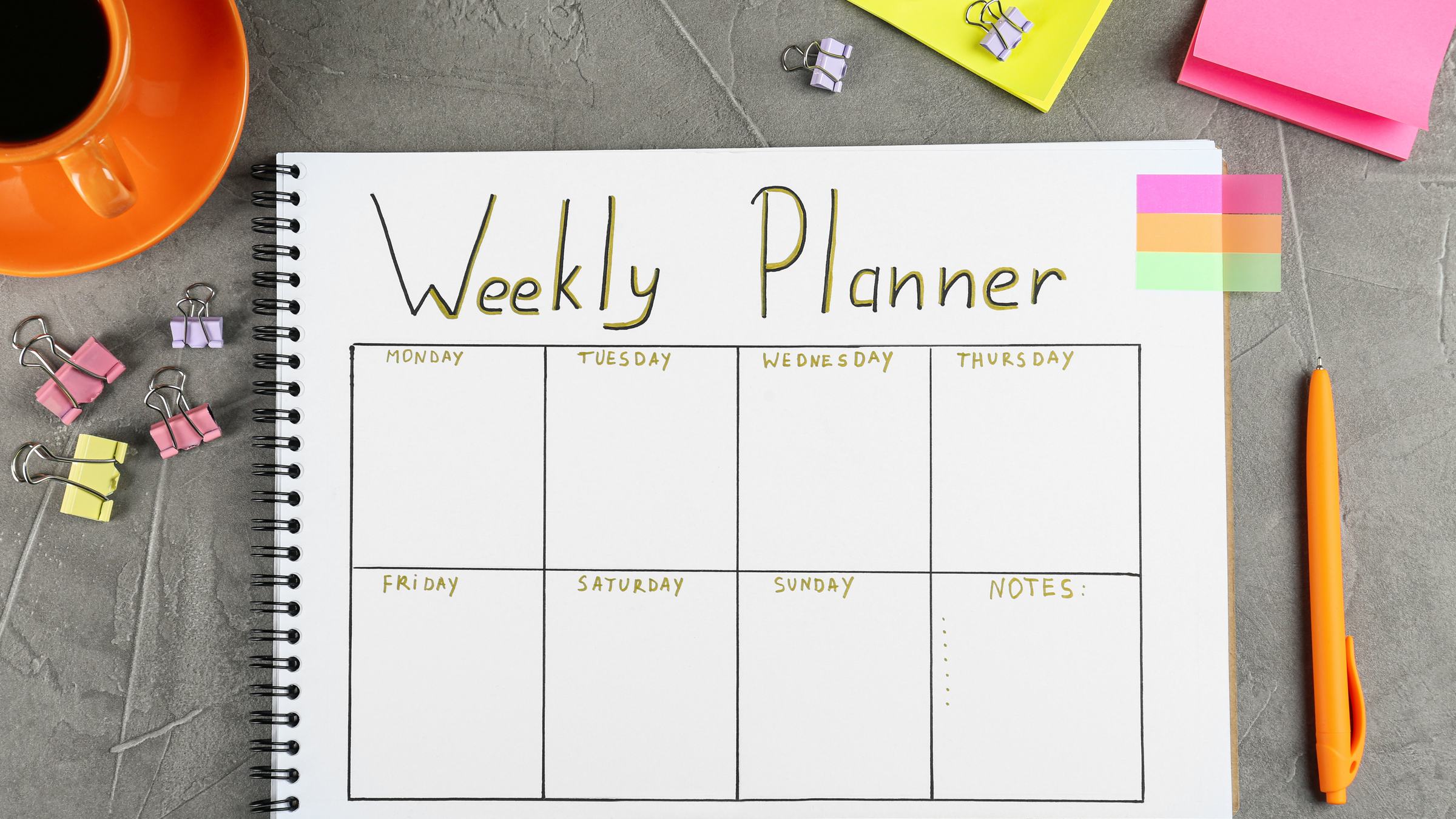 Weekly planner on a desk representing a weekly P&L routine